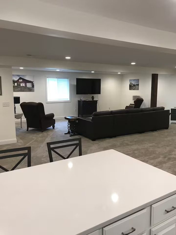 Modern basement living area with furniture