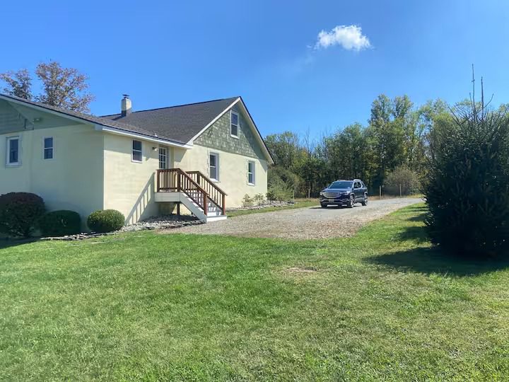 House with car on gravel driveway